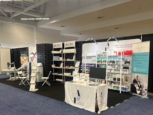 Trade show booth for A & E Beauty Supplies and Dectro International showing shelves with products on them
