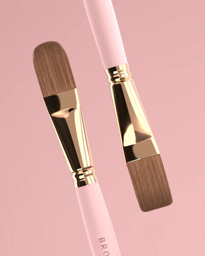 Brow Daddy Framework Master Brush, available in 2 options, for precise application in brow makeup and microblading, displayed on a clean, pink background , brush aside a bo
