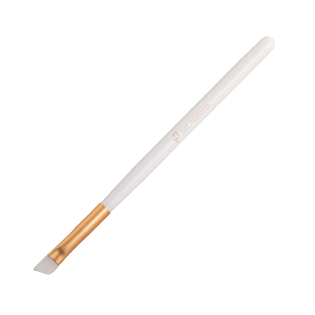 A sleek silicone brush with a flexible, soft tip for precise application of beauty products, brow, lash, and skincare treatments, displayed on a clean, neutral background.